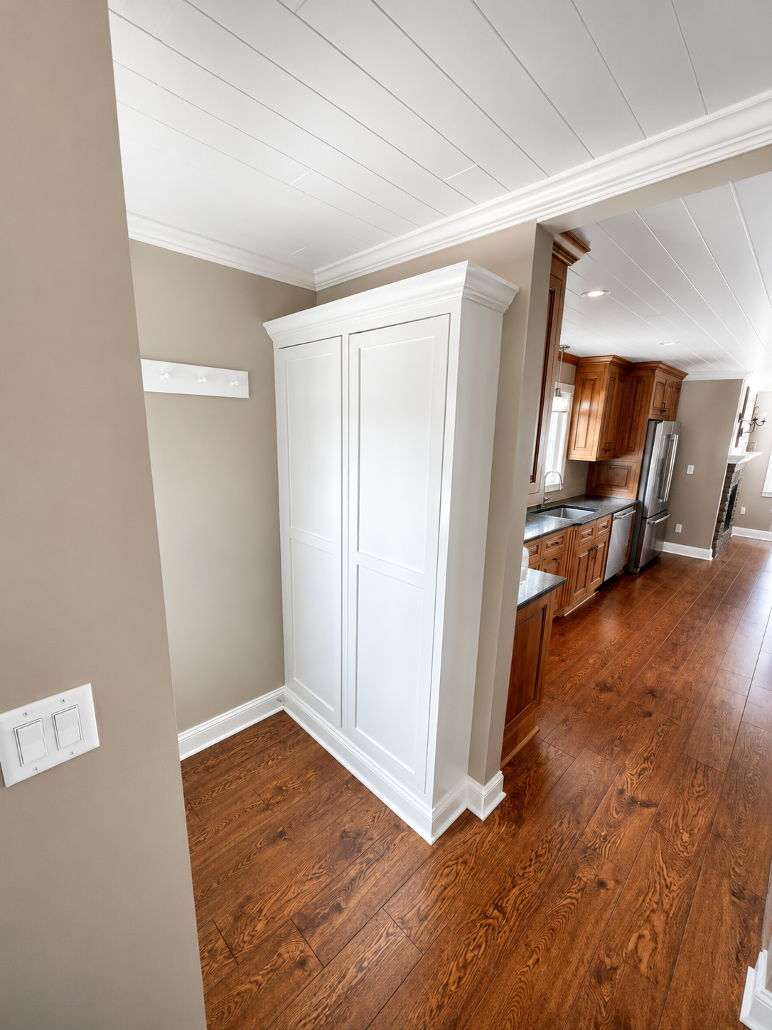 The corner between the back door and the kitchen