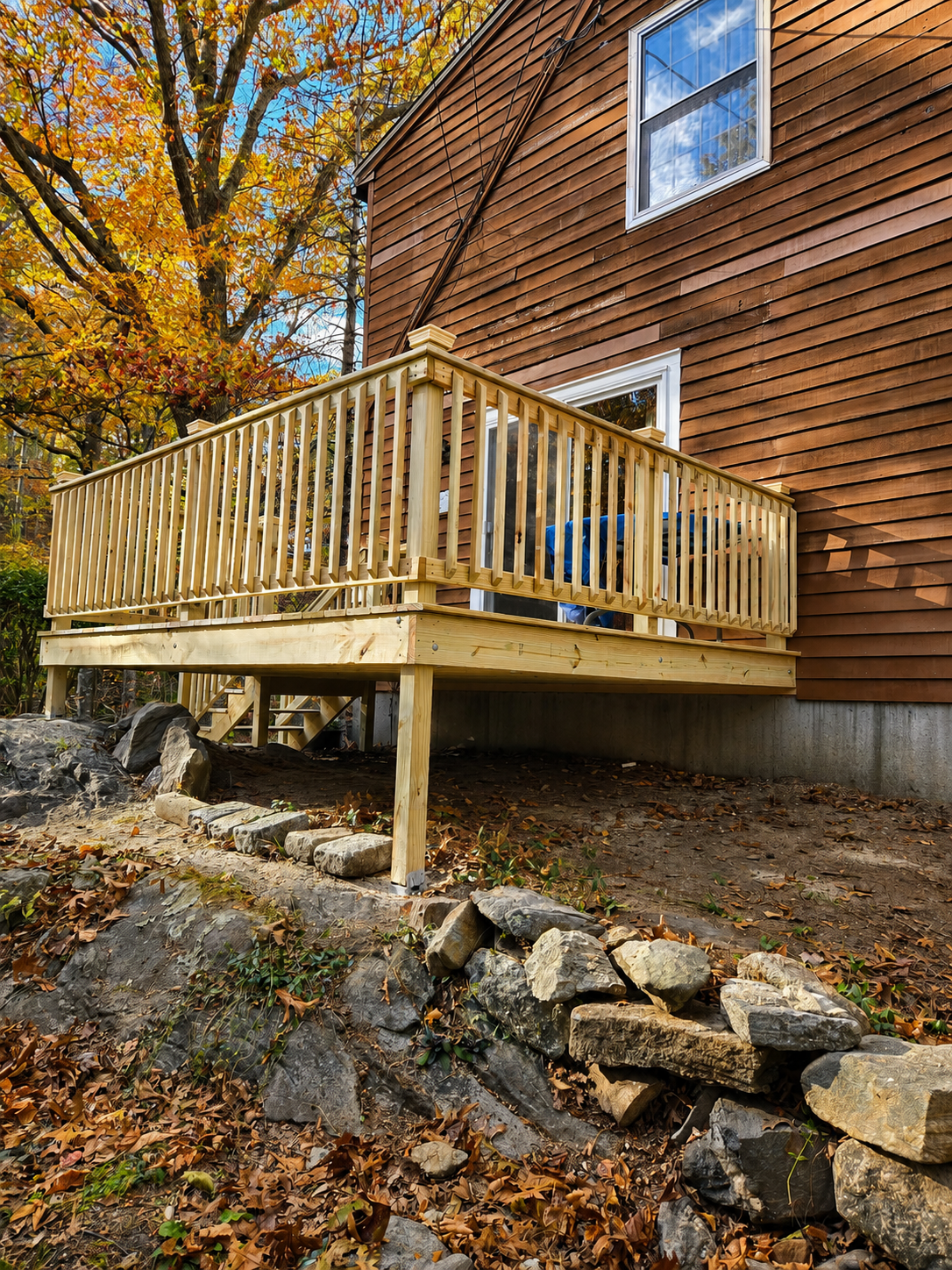 Pressure-treated deck on rock ledge